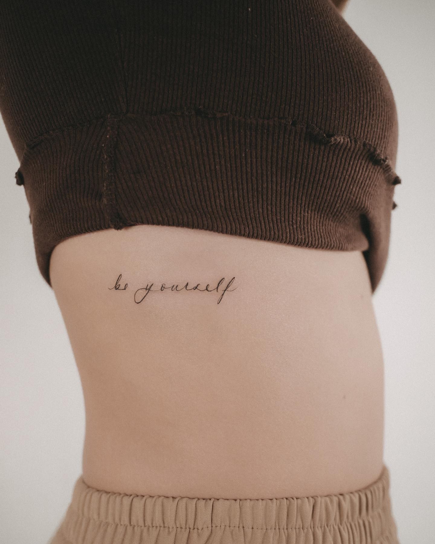 ‘Be Yourself’ Lettering Tattoo On Rib Side