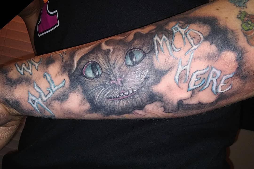 Cheshire Cat Tattoo All Over The Forearm With Text