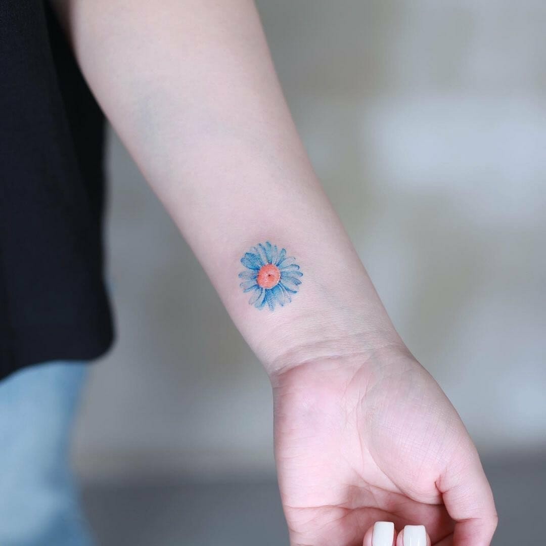 The Blue Daisy Tattoo Of Loyalty On Wrist