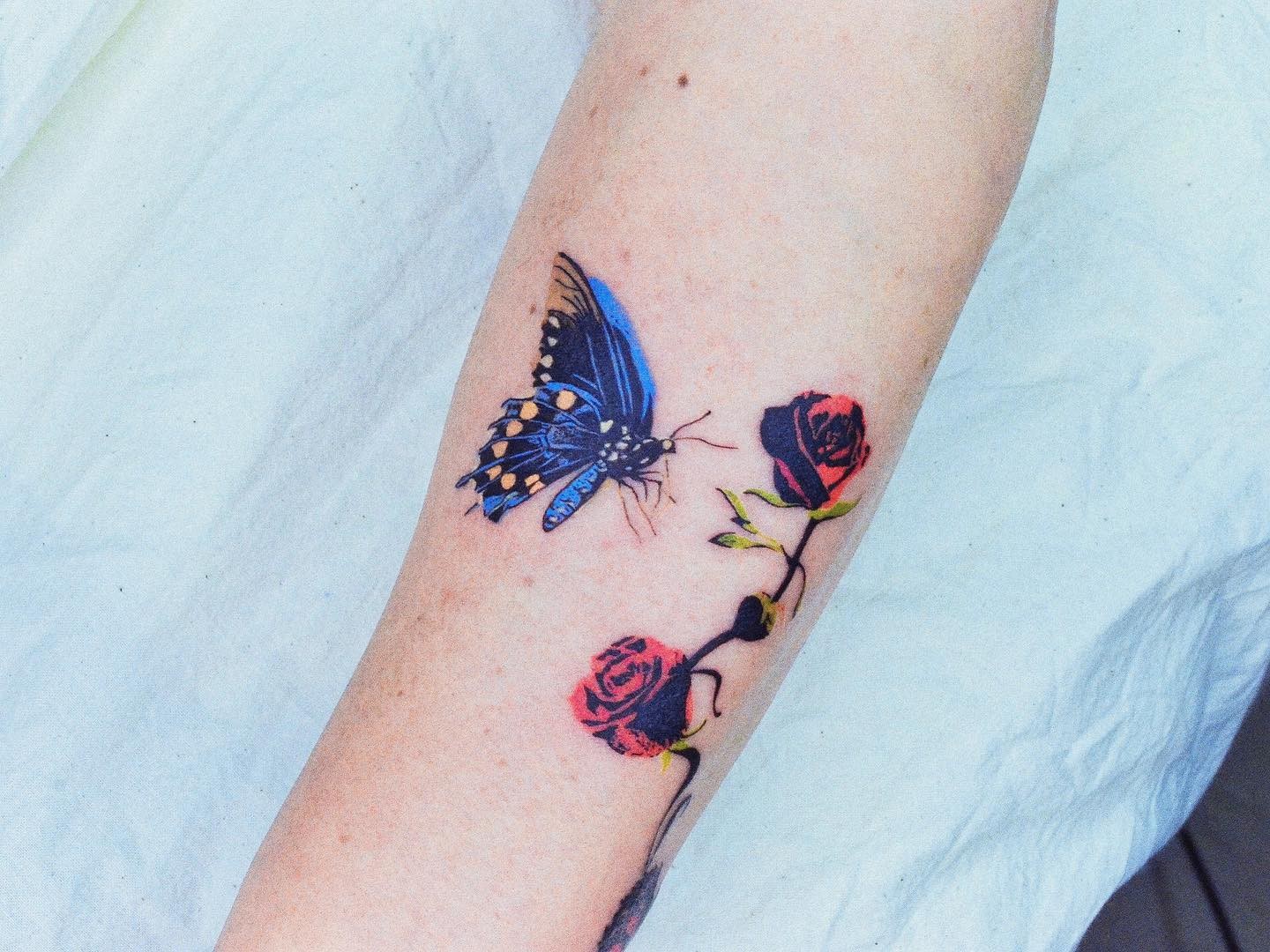 Tiny Blue Butterfly Tattoo