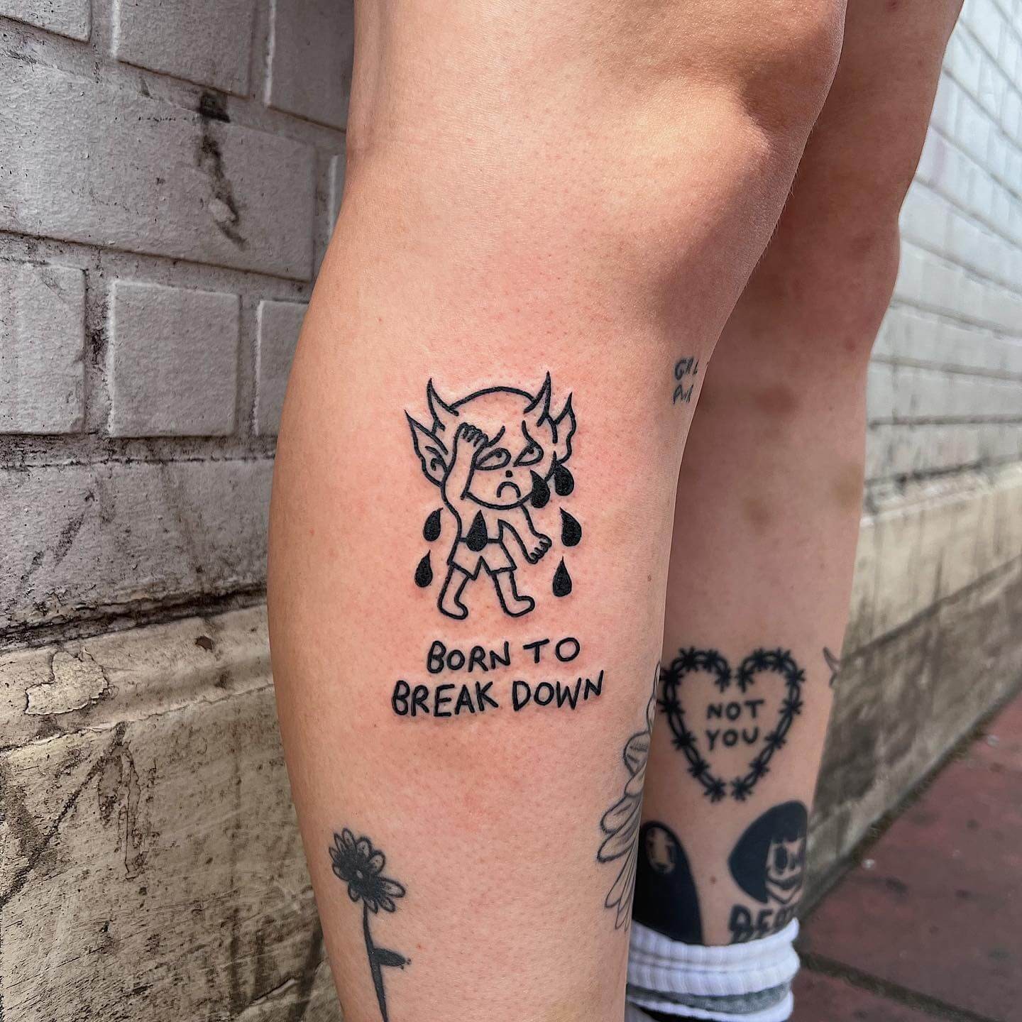 Crying Baby Devil Tattoo With A Phrase Motif