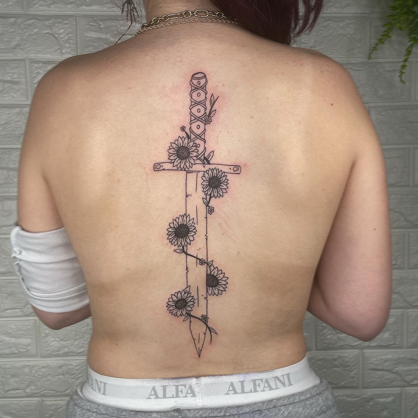 Sword Symbol Spine Tattoo