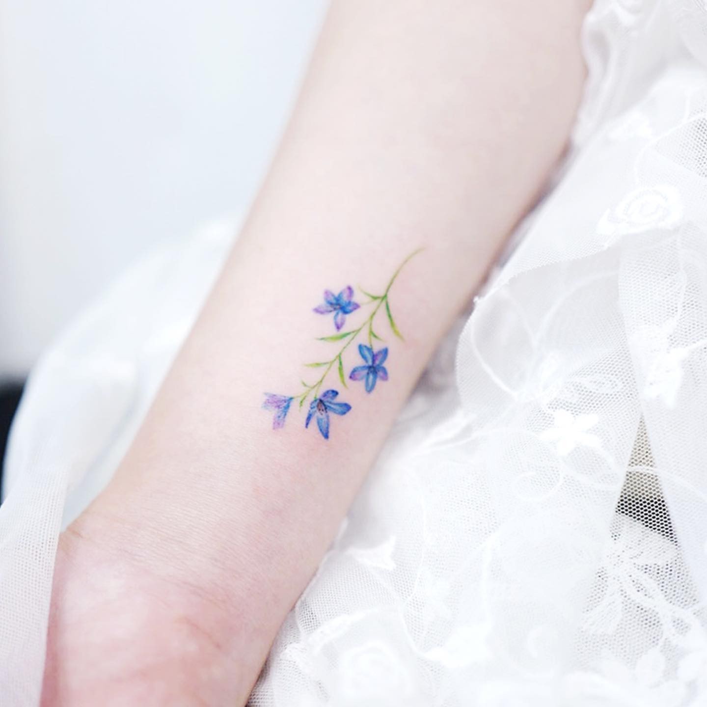 Minimalistic Watercolor Effect Delphinium Tattoo