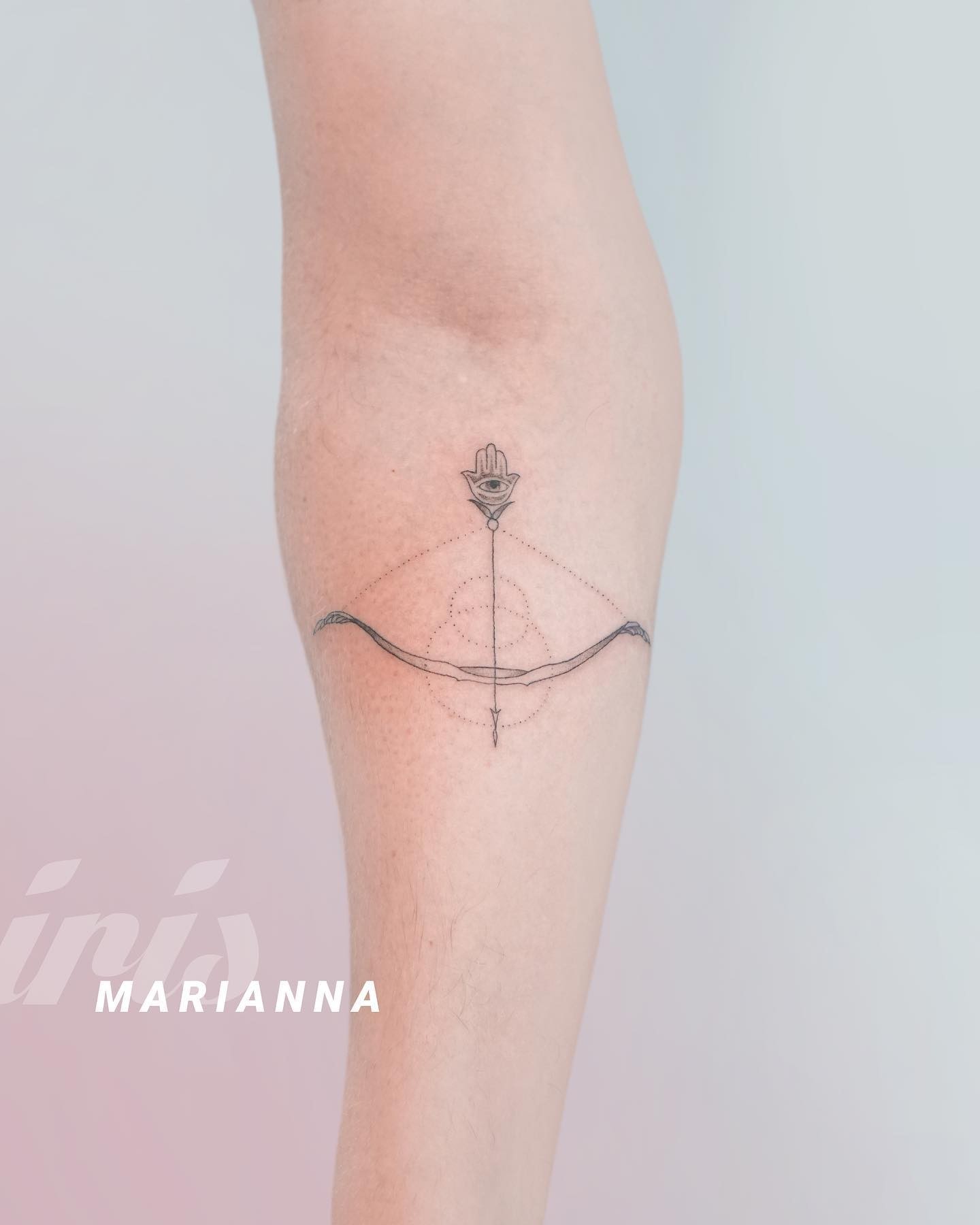 Minimalist Bow And Arrow Tattoo In Black And White