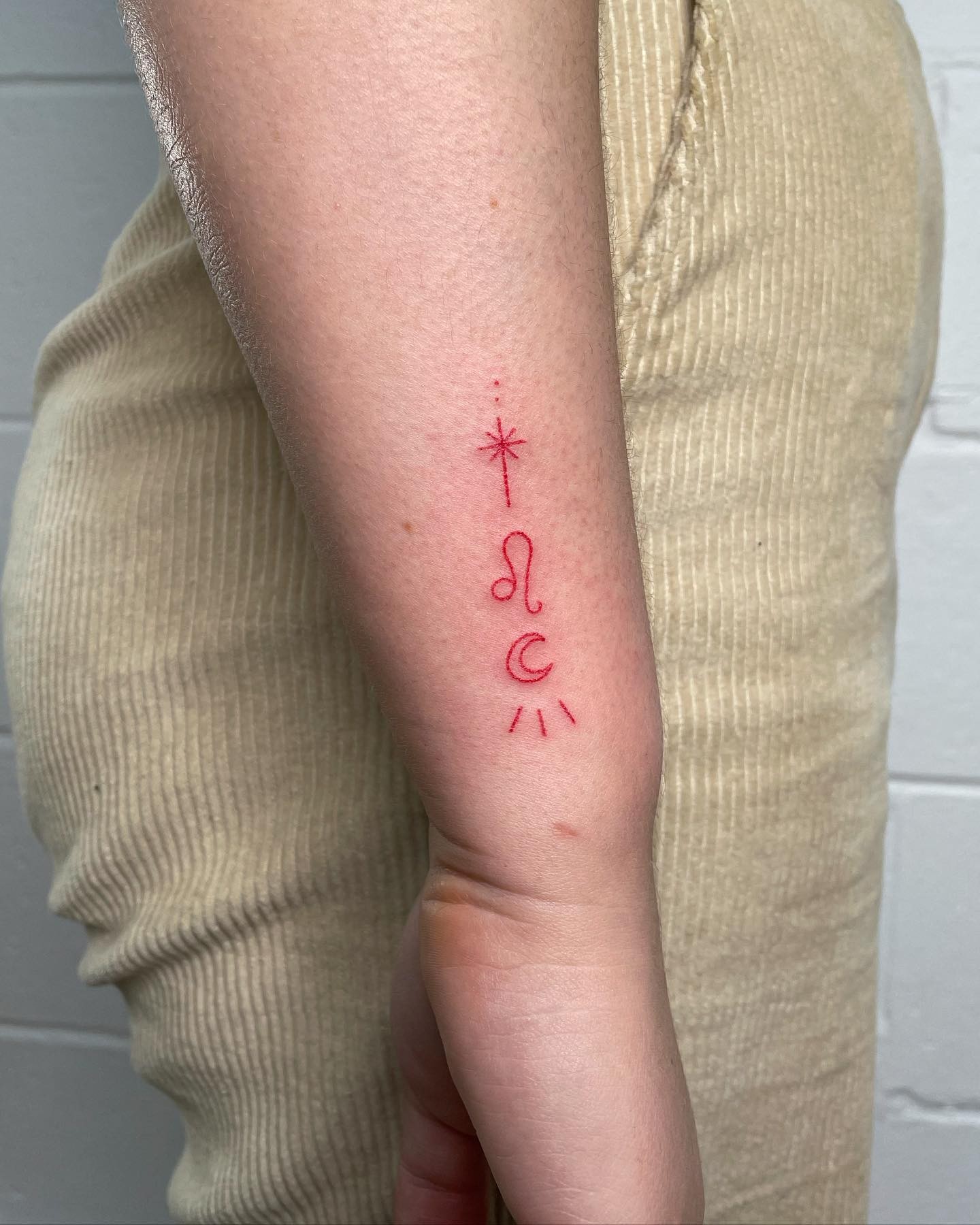 Leo Sign Tattoo In Red