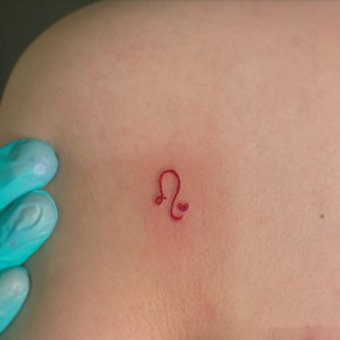 Leo Sign Tattoo In Red