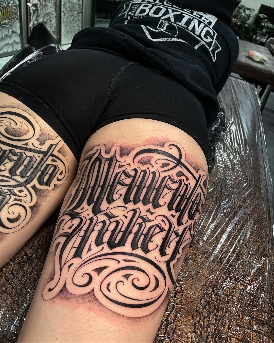 Large Back Of The Thigh Lettering Tattoo