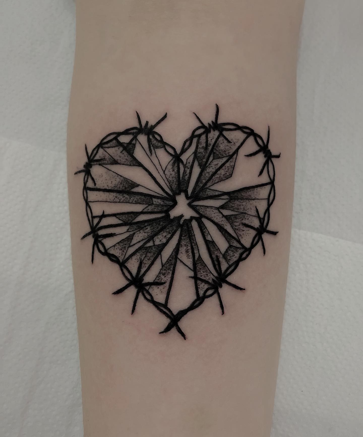 Broken Glass Heart With Barb Wire Framing Tattoo