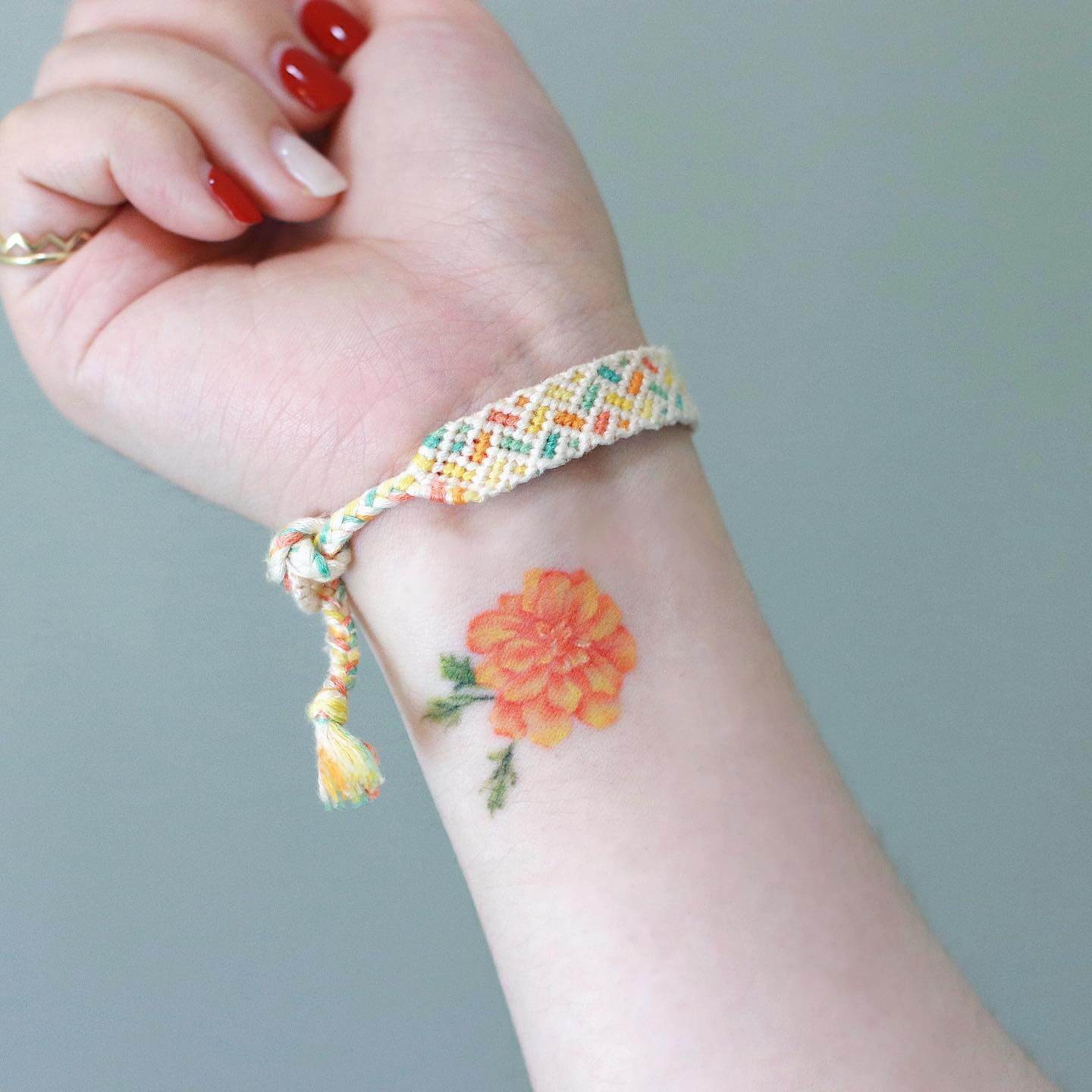 Delicate Small Marigold on Wrist Tattoo