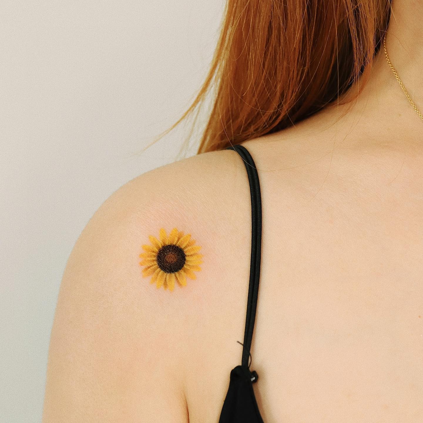 Minimalistic Women’s Sunflower Shoulder Tattoo