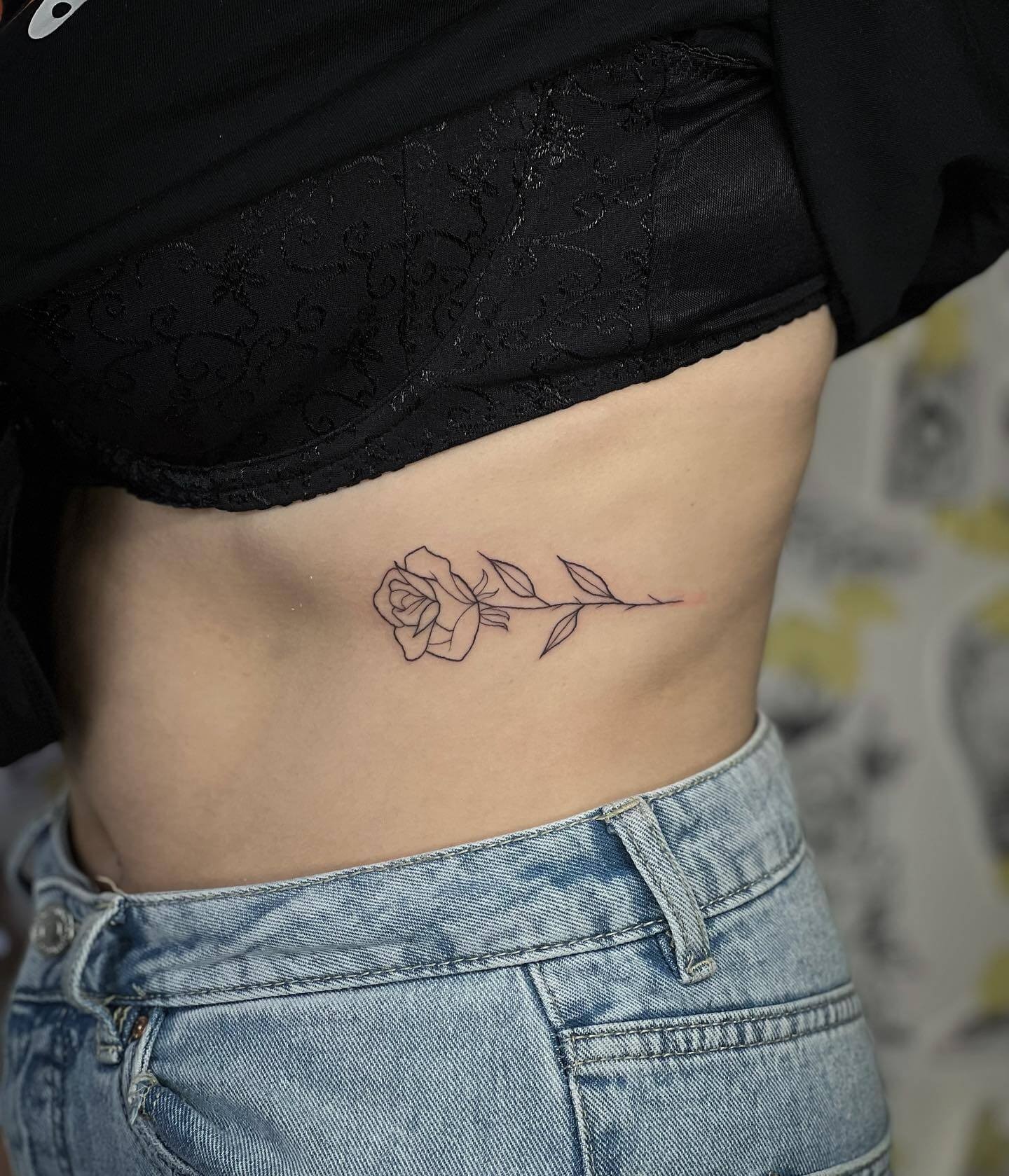 Outlined Small Rose Tattoo Having Thorns