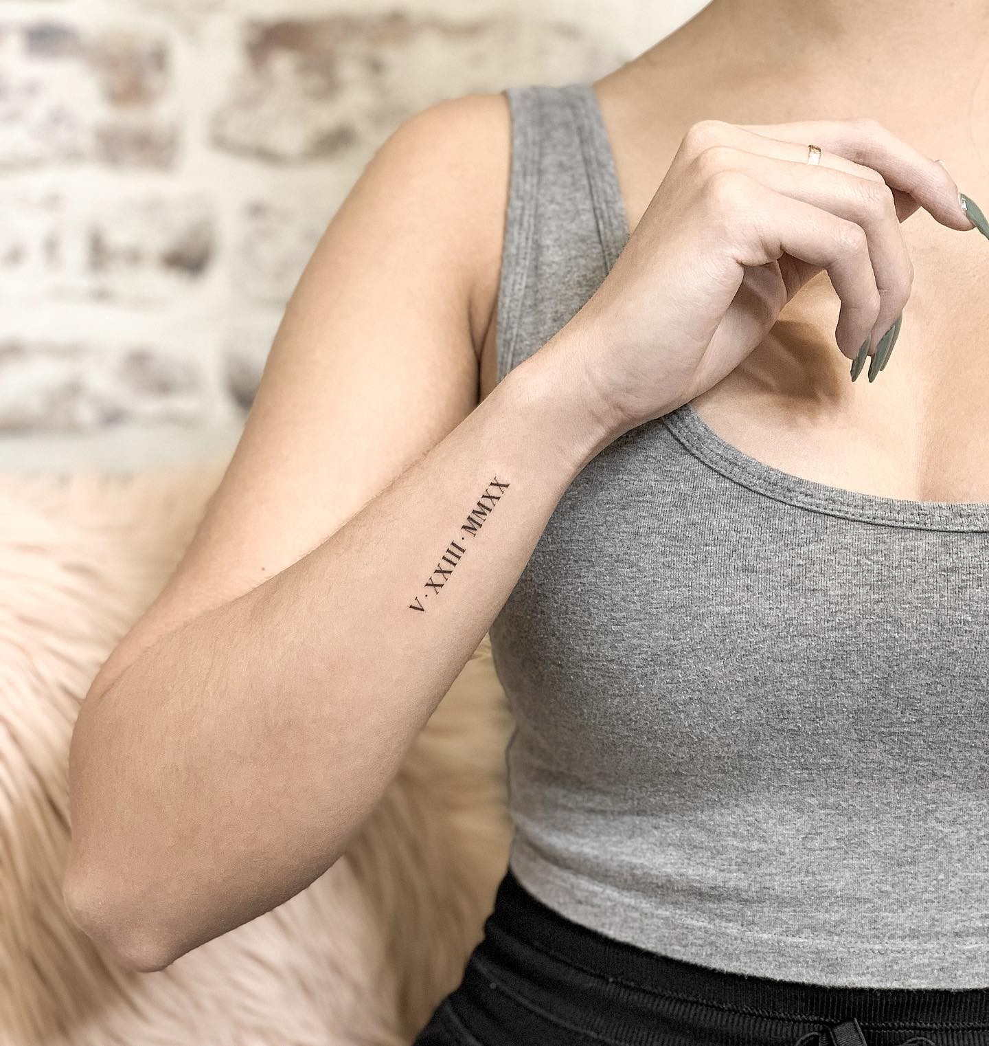 Minimalistic Roman Numerals Tattoo On Wrist