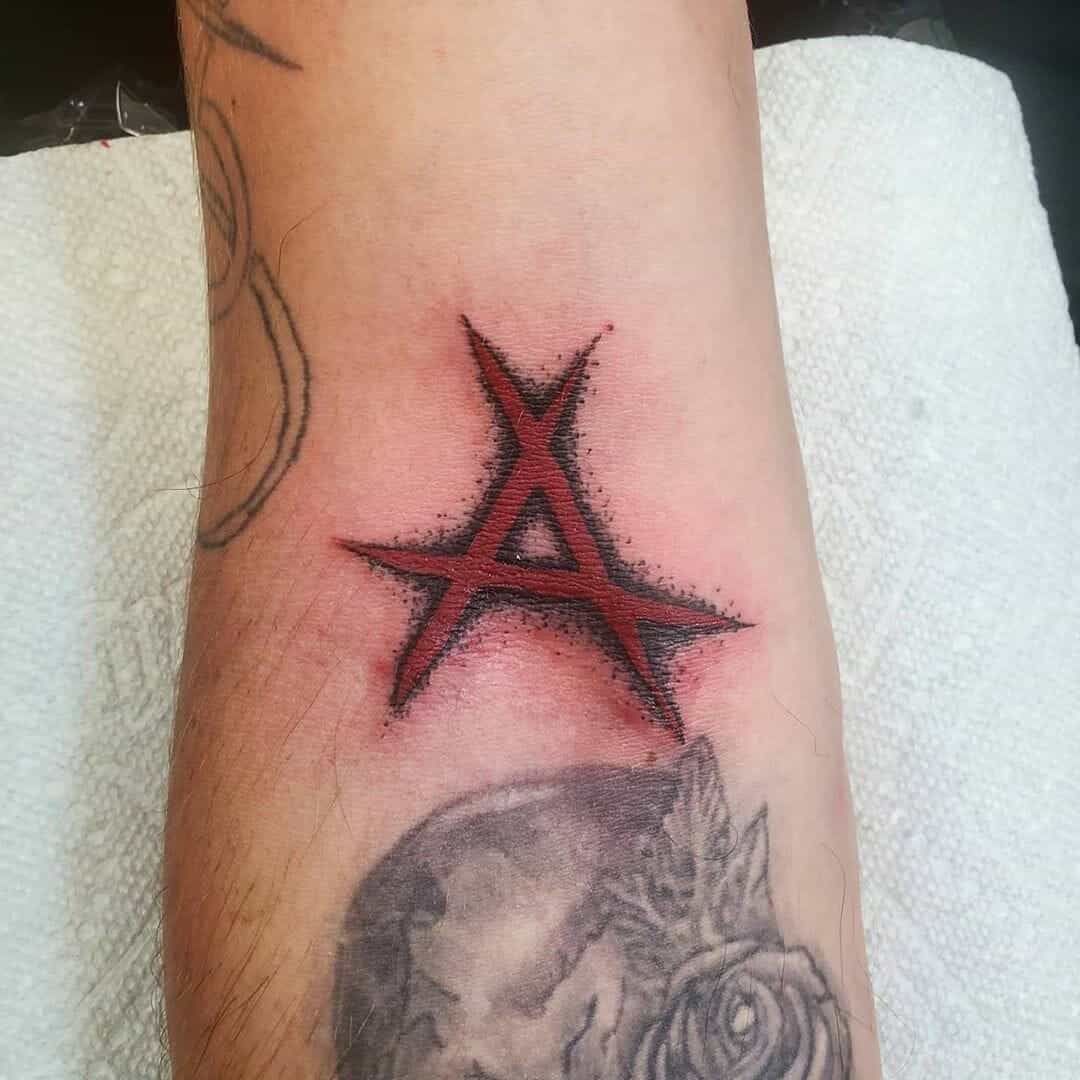 Red Fake Skin Scar Shaped Like Anarchy Symbol Tattoo Design