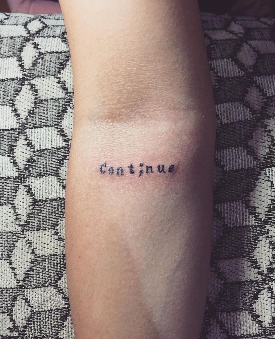 Continue And Semicolon Tattoo On Forearm