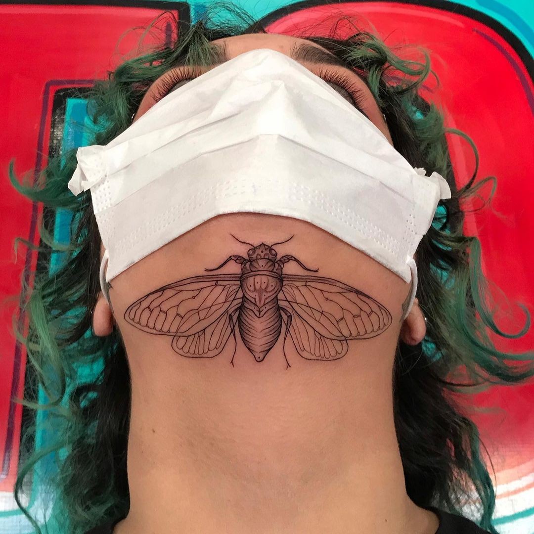 Insect Under Chin Tattoo