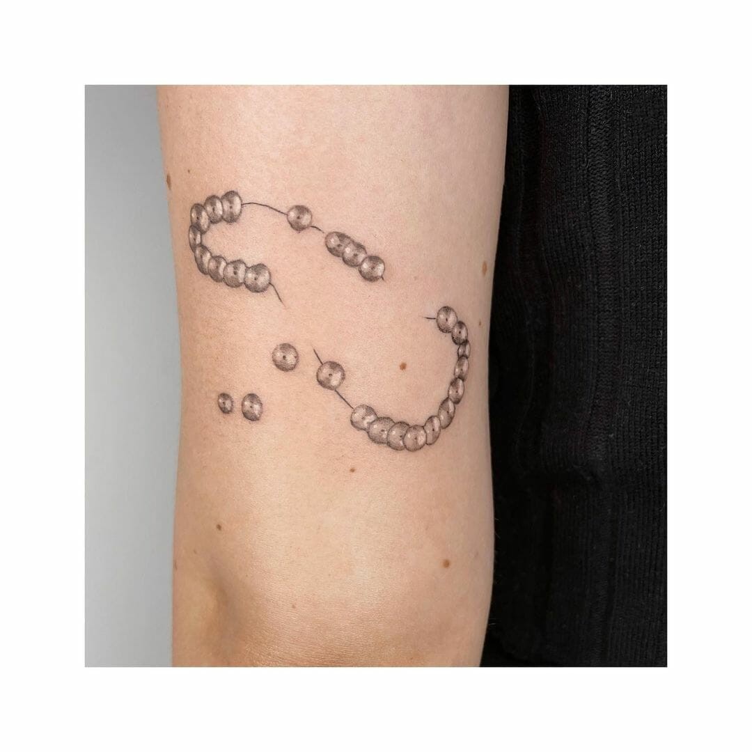 Pearl In A String Arm Tattoo