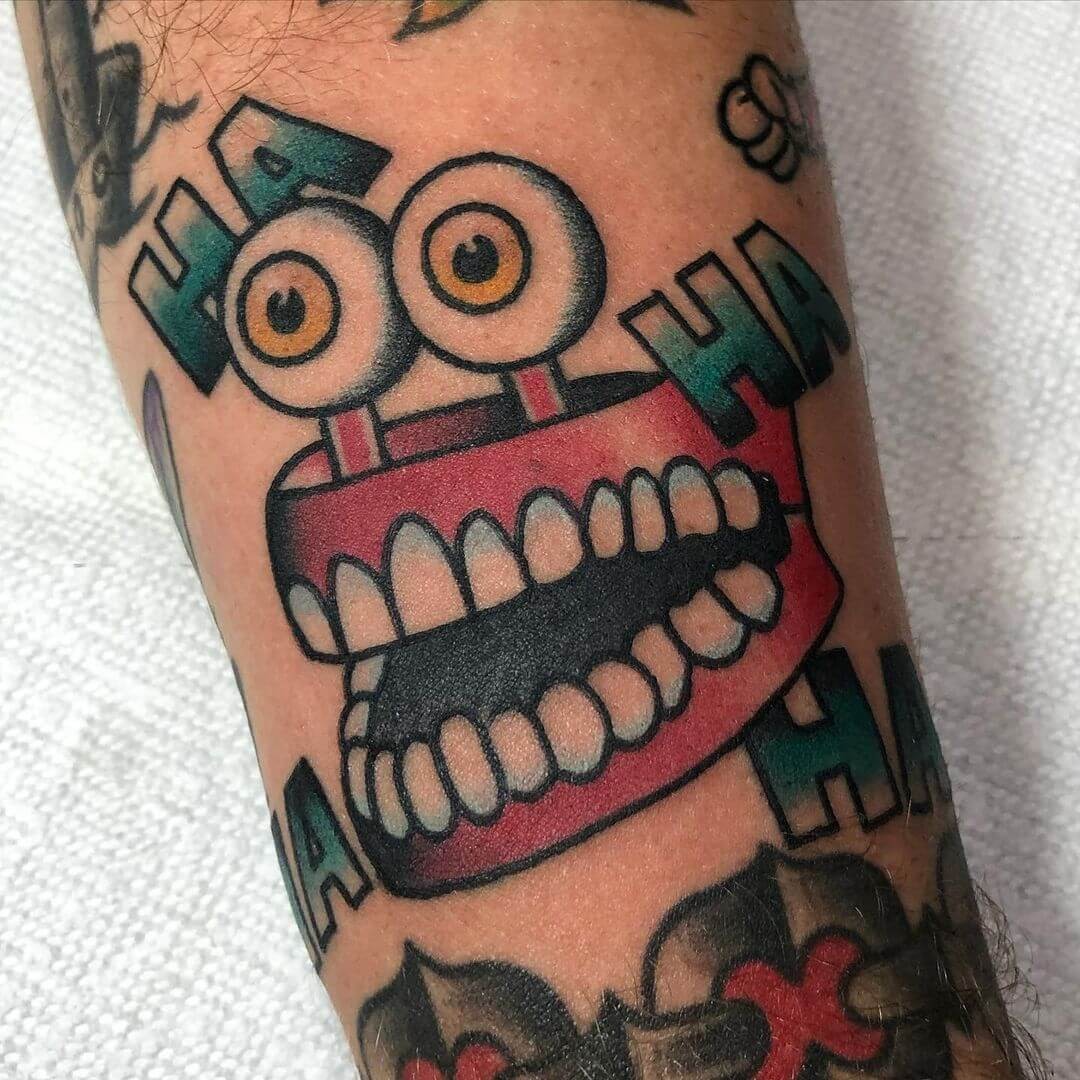 Cartoon Themed Laugh Hand Tattoo