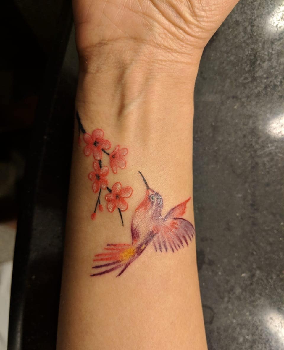 Small Hummingbird With Flowers Tattoo