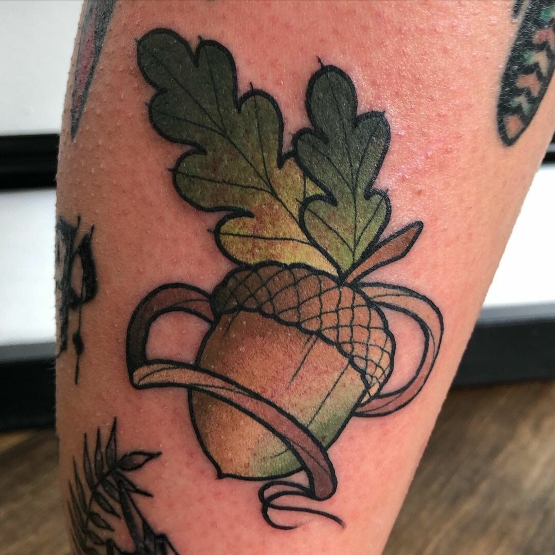 Neo-Traditional Black And Golden Acorn Tattoo