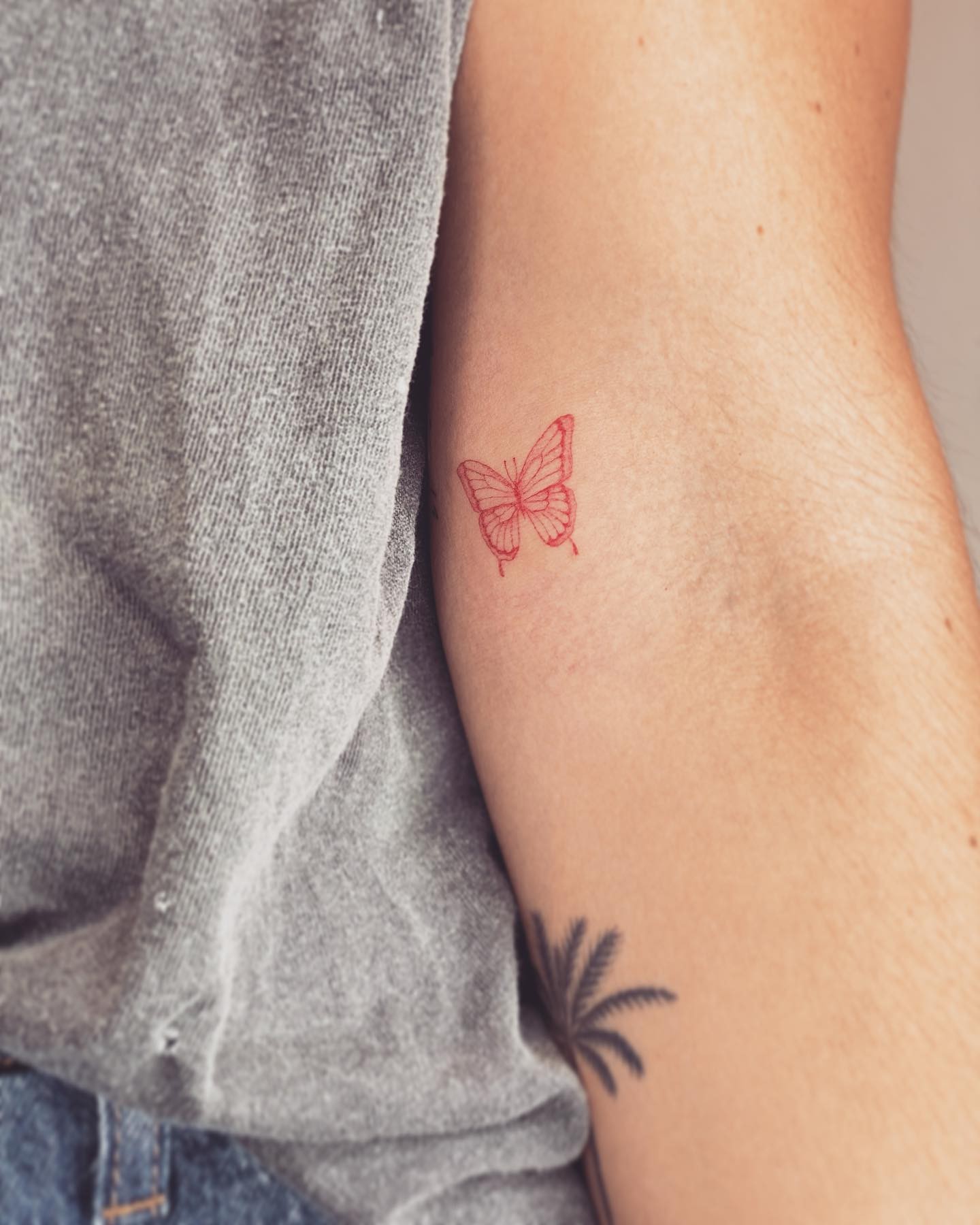 Red Outlined Butterfly Tattoo