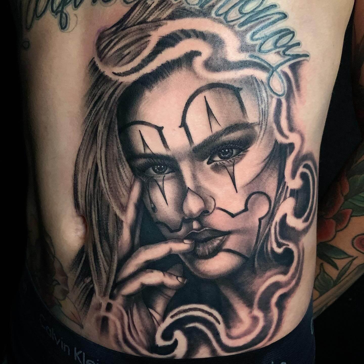 Intriguing Female Cholo Tattoo With Cholo Font