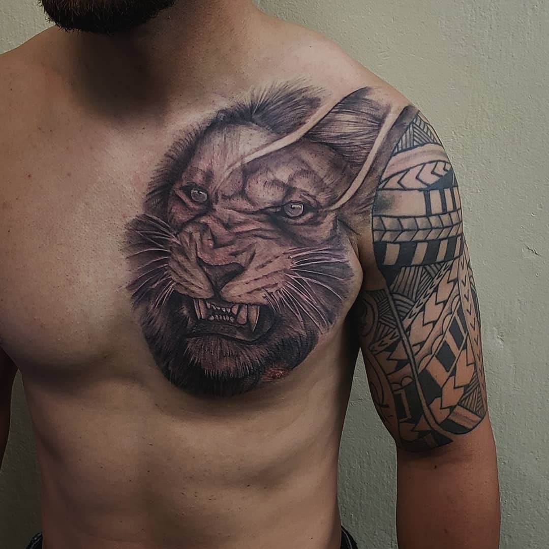 Lion Ripping Through Skin Tattoo