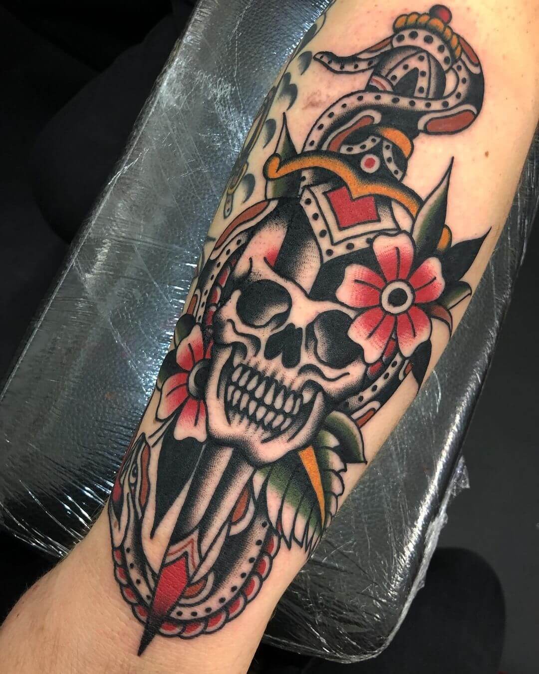 Dagger Piercing Skull Tattoo