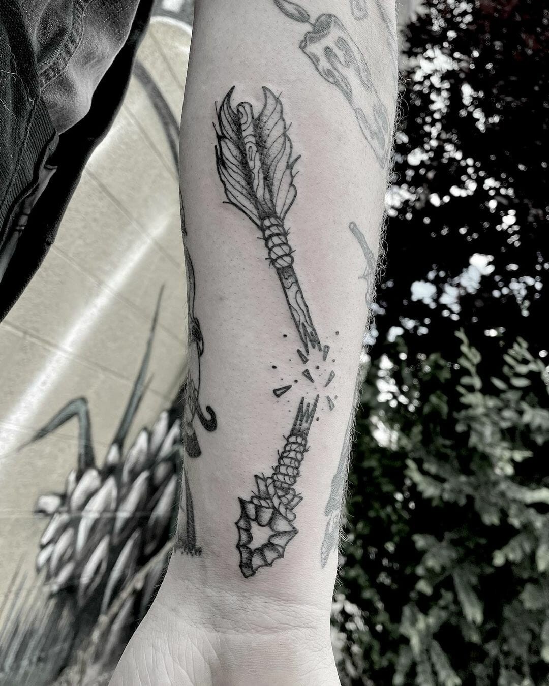 Black And Bold Broken Arrow Tattoo