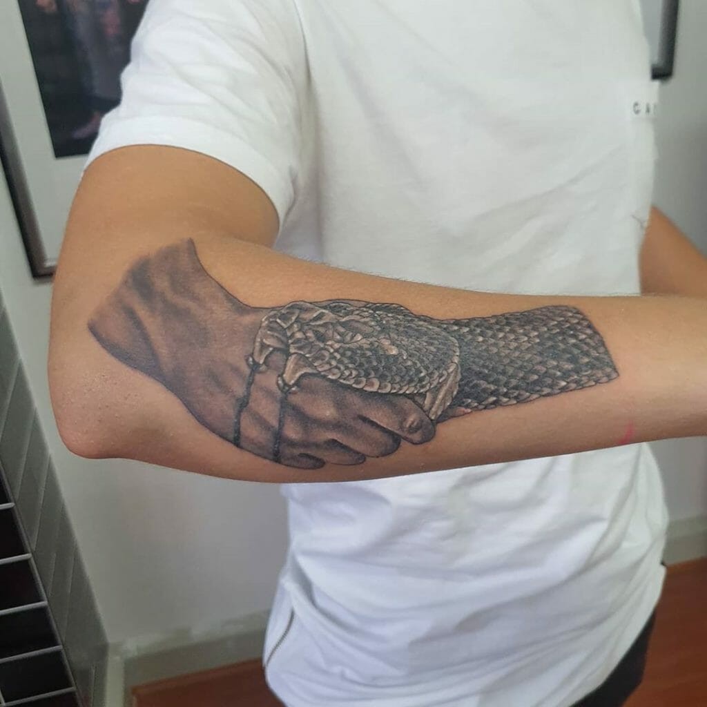 Realistic Greyscale Snake Biting Handshake Trust No One Tattoo Arm Placement