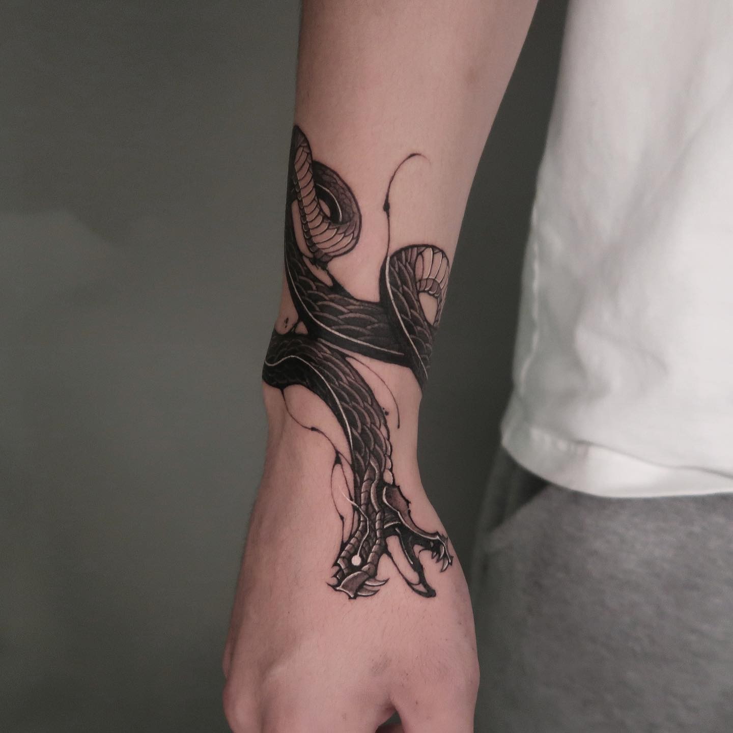 Fantastic Black and White Snake Tattoo on Wrist