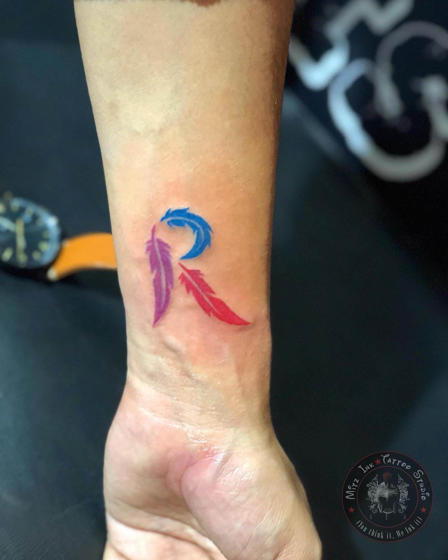 Colorful R Tattoo With Feathers