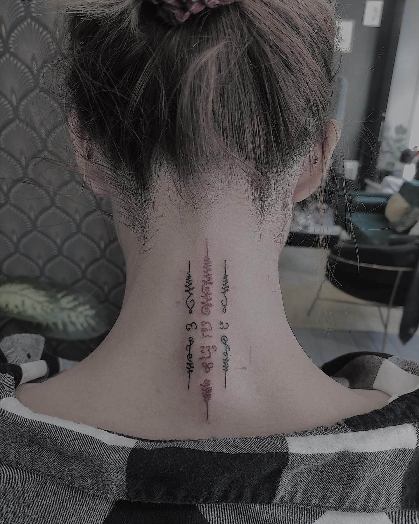 Simple Sak Yant Tattoos on Neck