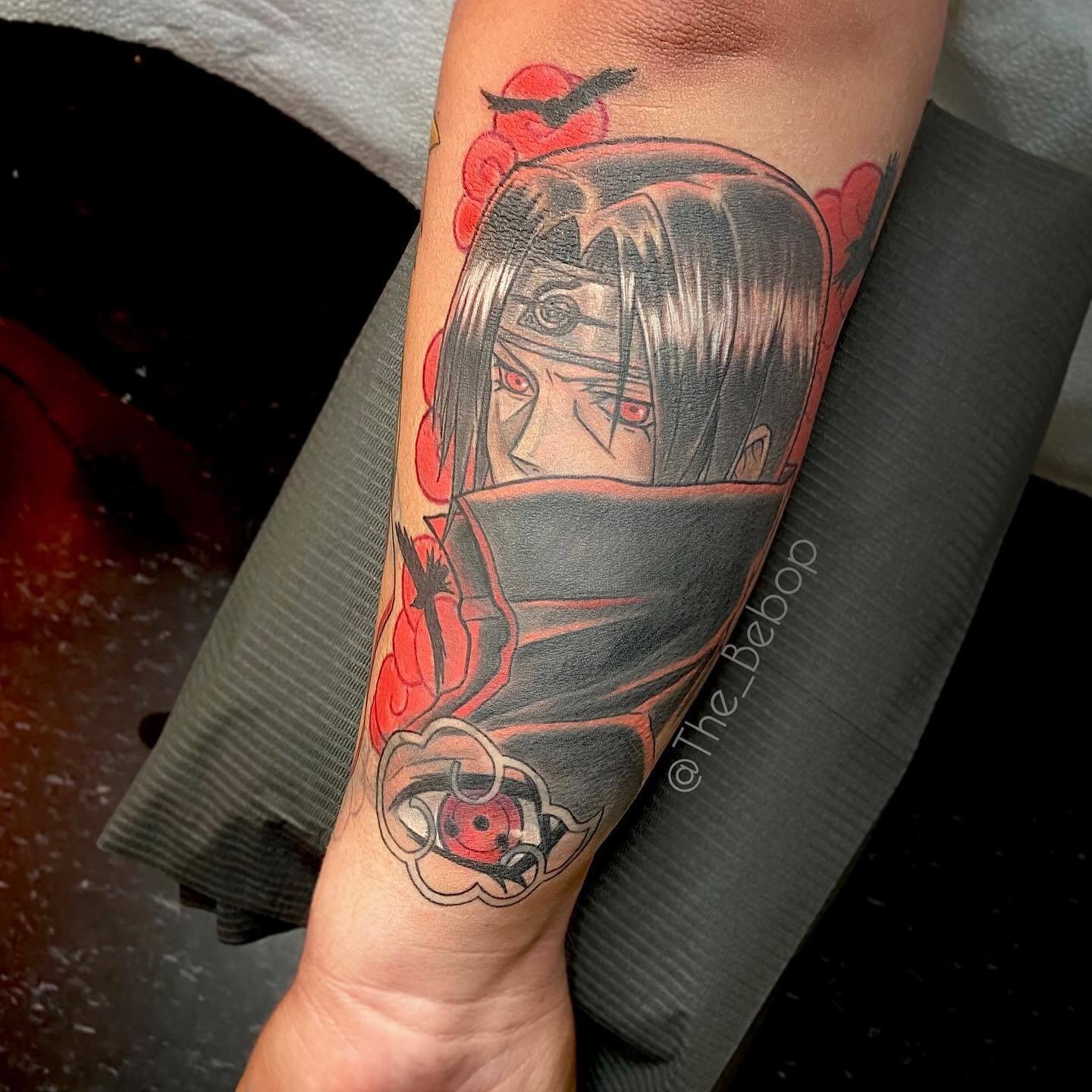 Itachi’s Sharingan Eye in Akatsuki Cloud Tattoo Design