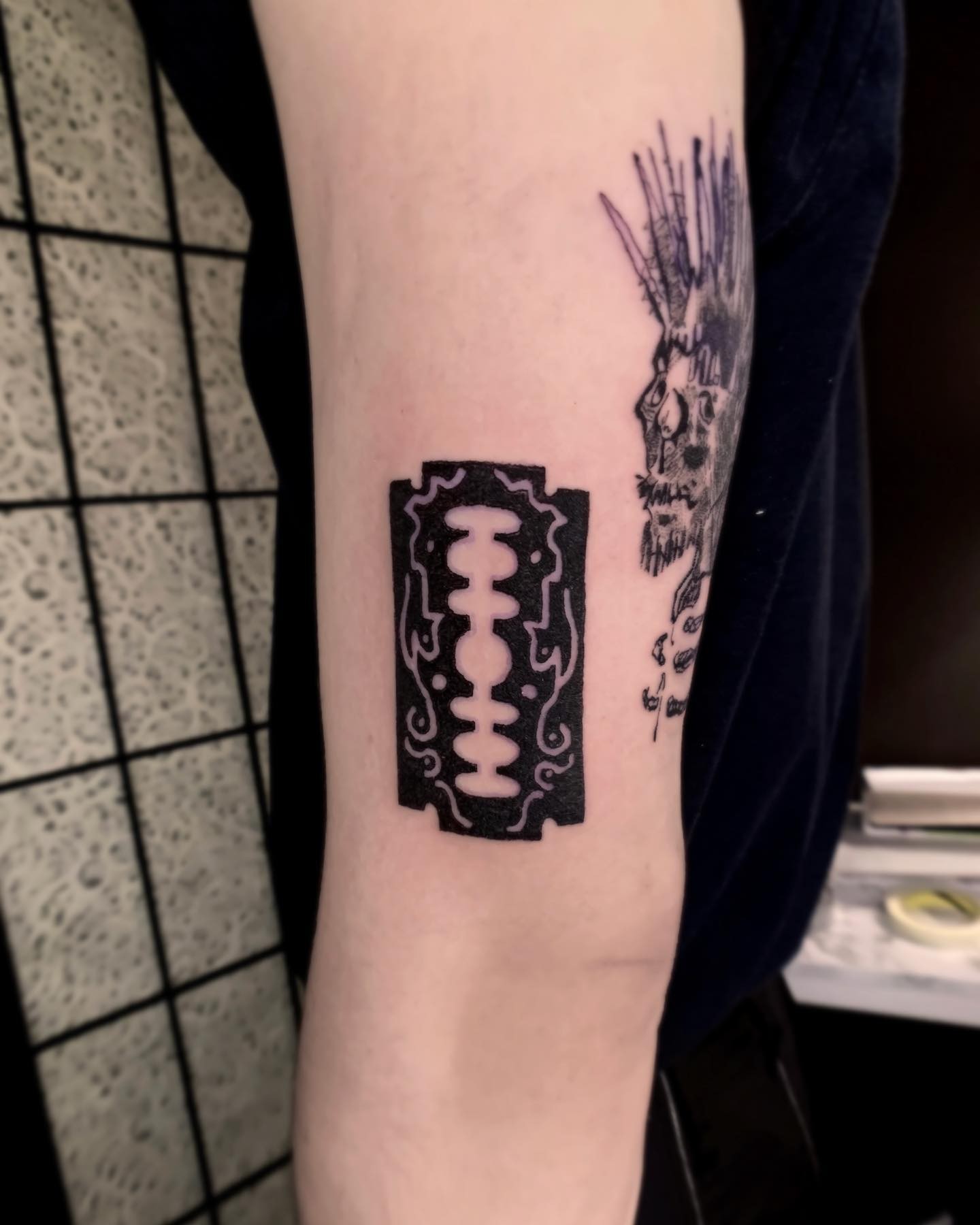 Patterened Razor Blade Bicep Tattoo