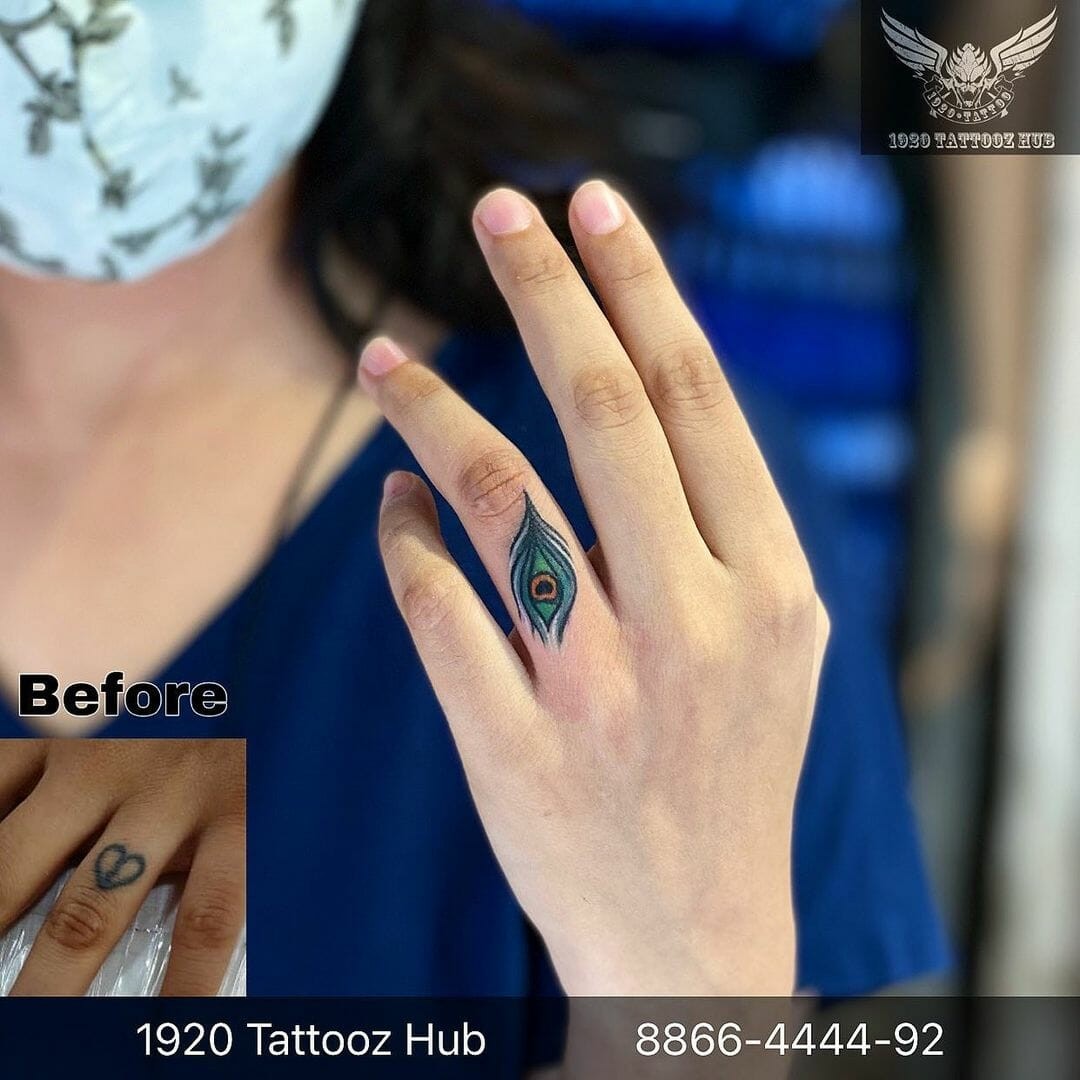 The Tiny Peacock Feather Tattoo On Finger