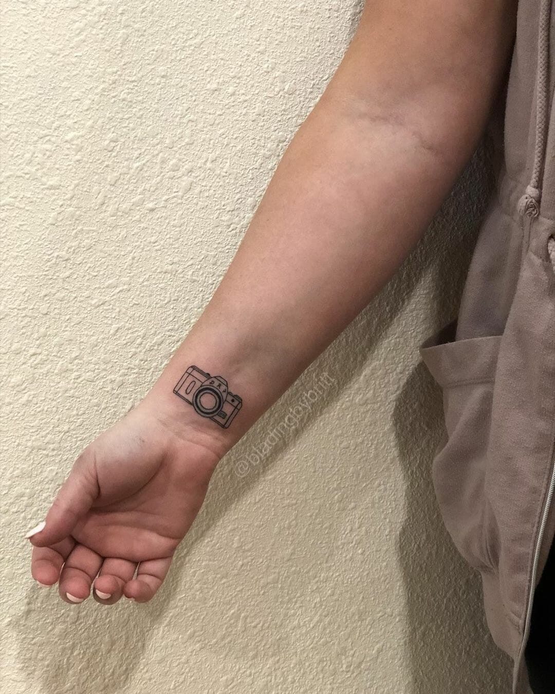 Small Camera Tattoo On Wrist