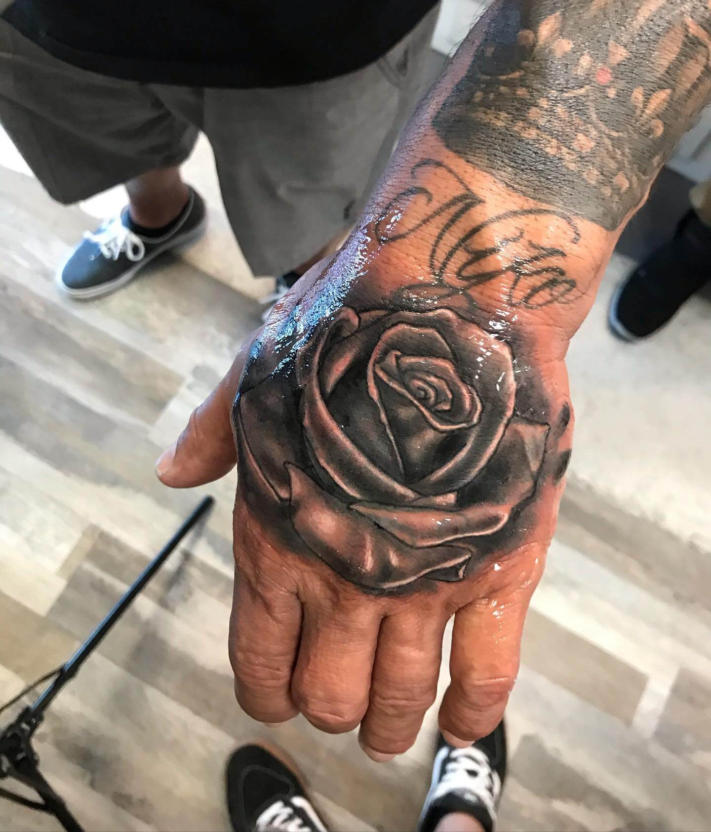 Dynamic Black And Grey Rose Hand Tattoo