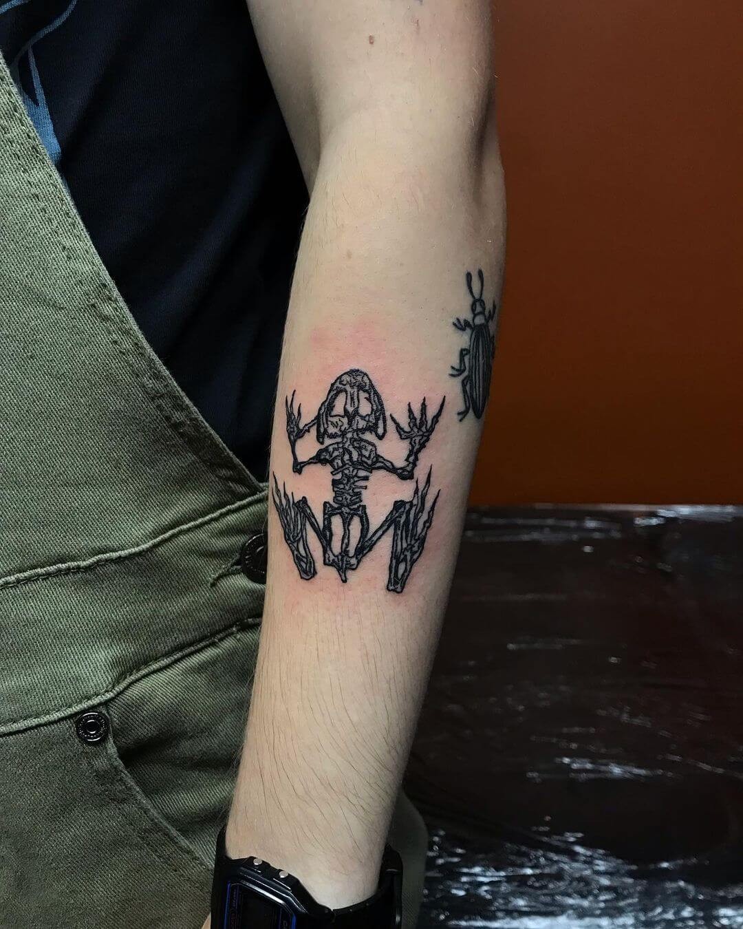 Small Bone Frog Tattoo On Arm