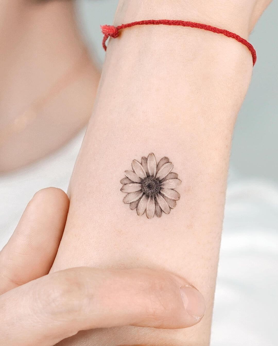 The Cute Black Ink Tiny Daisy Tattoo