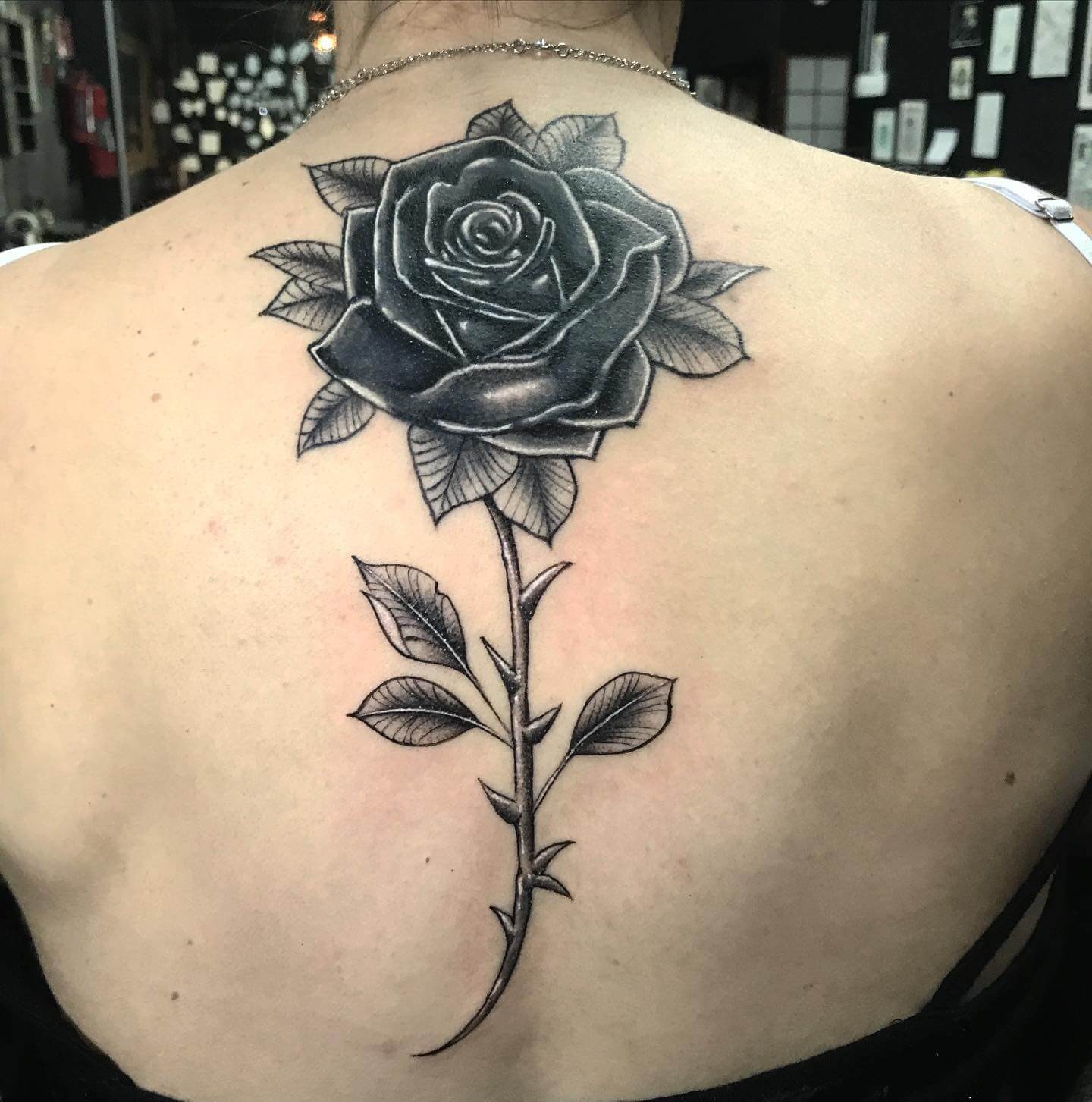 Dark Tones Black Rose Tattoo On Back