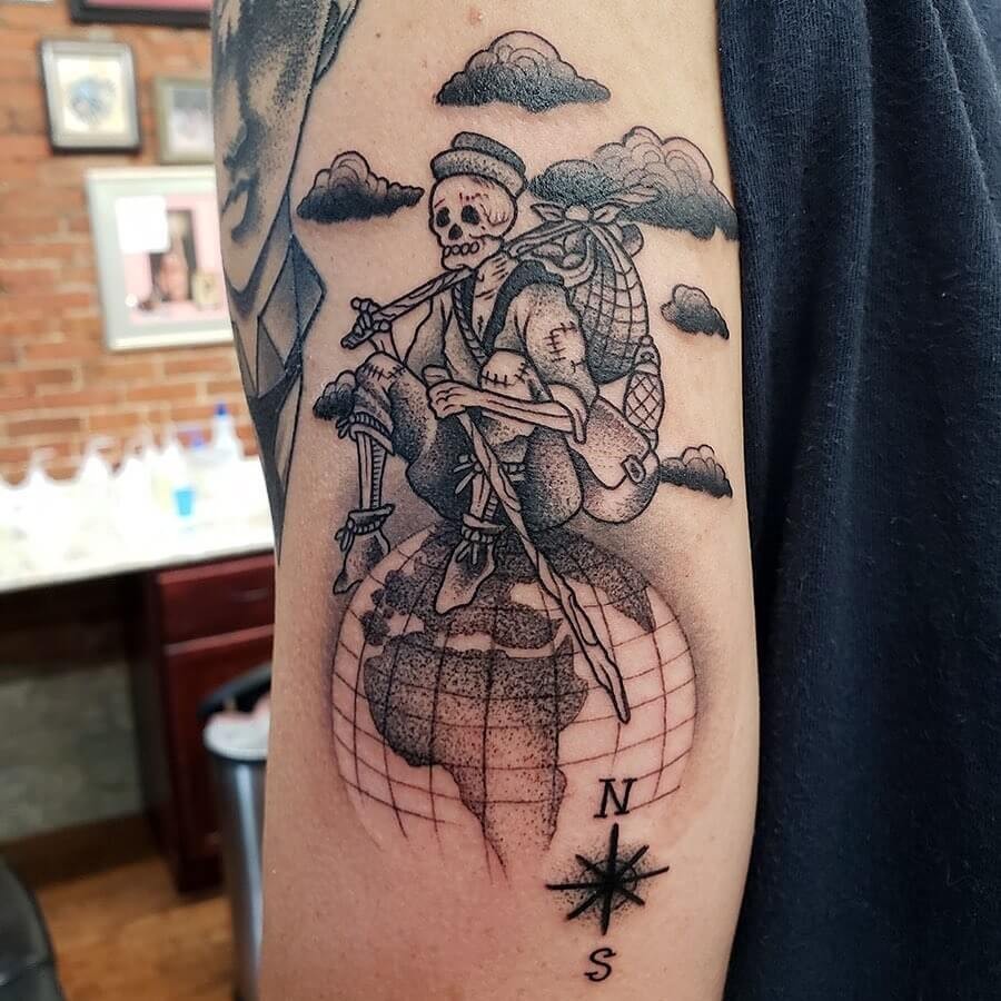 Hiker Skeleton Sitting On The Globe Tattoo