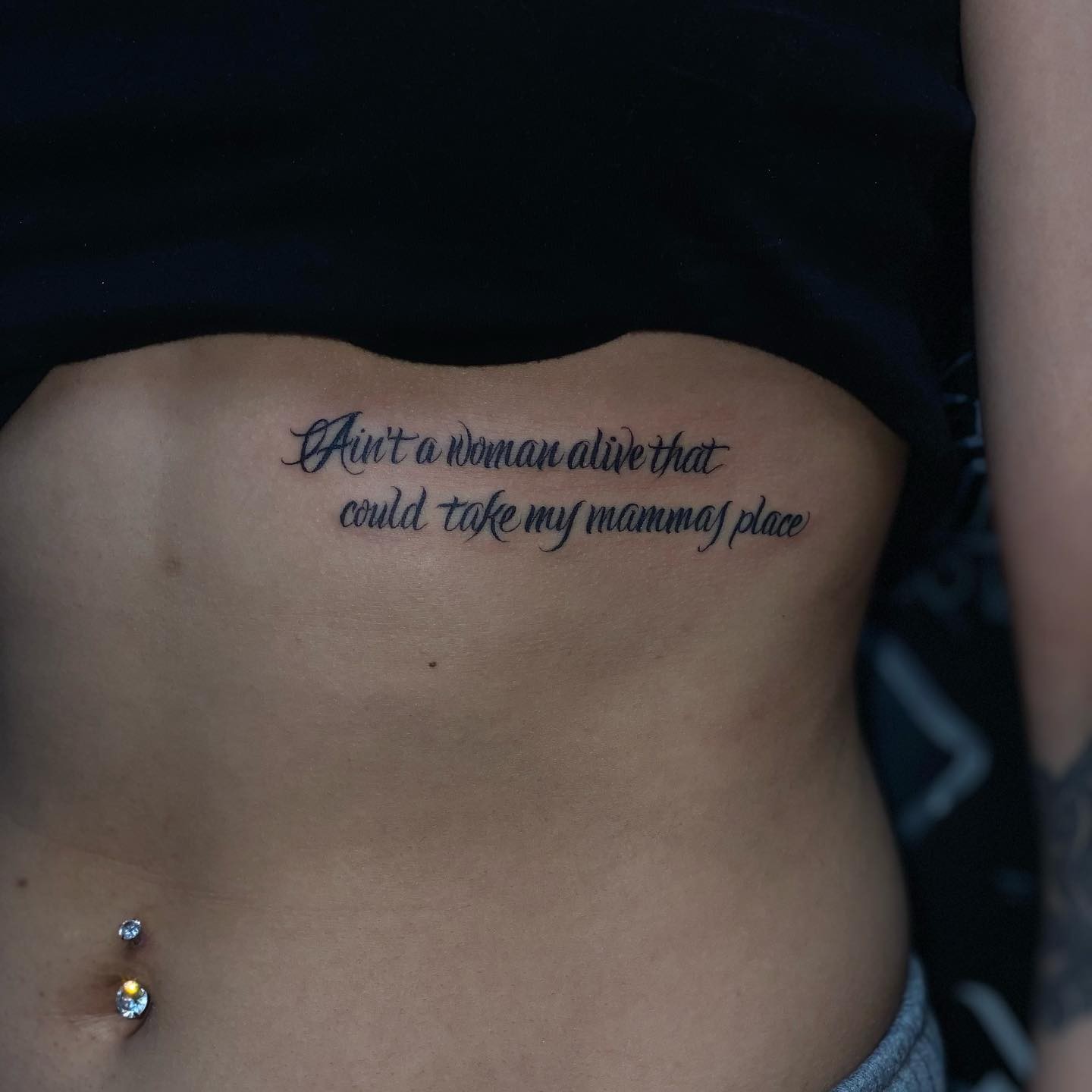 Bold Lines Underboob Quote Tattoo