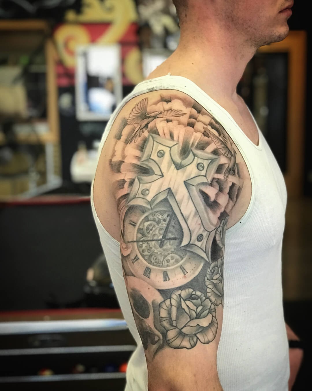 Half-Sleeve Metallic Cross With Clouds Tattoo Design