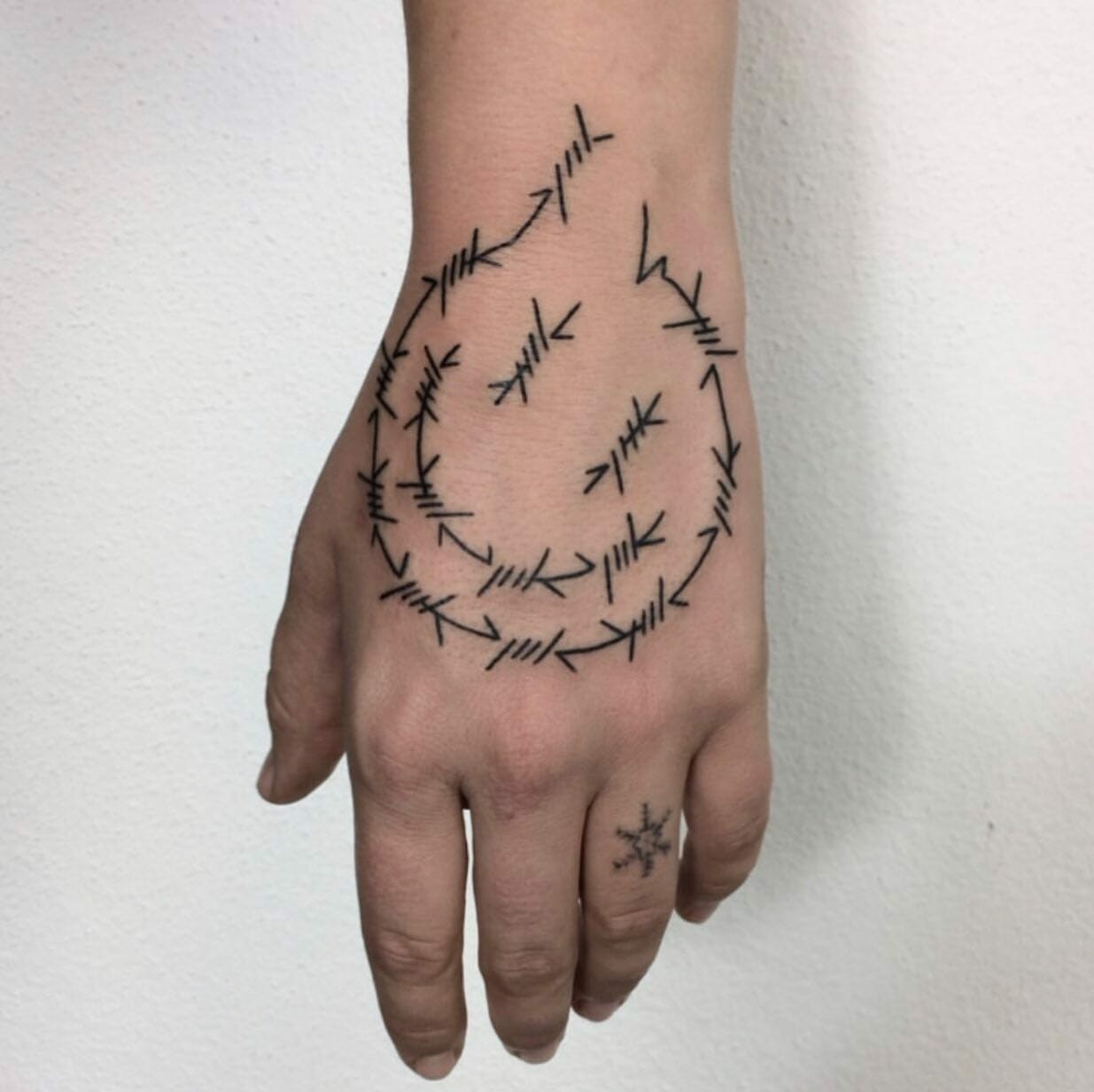 Barbed Wire Smiley Face Tattoo