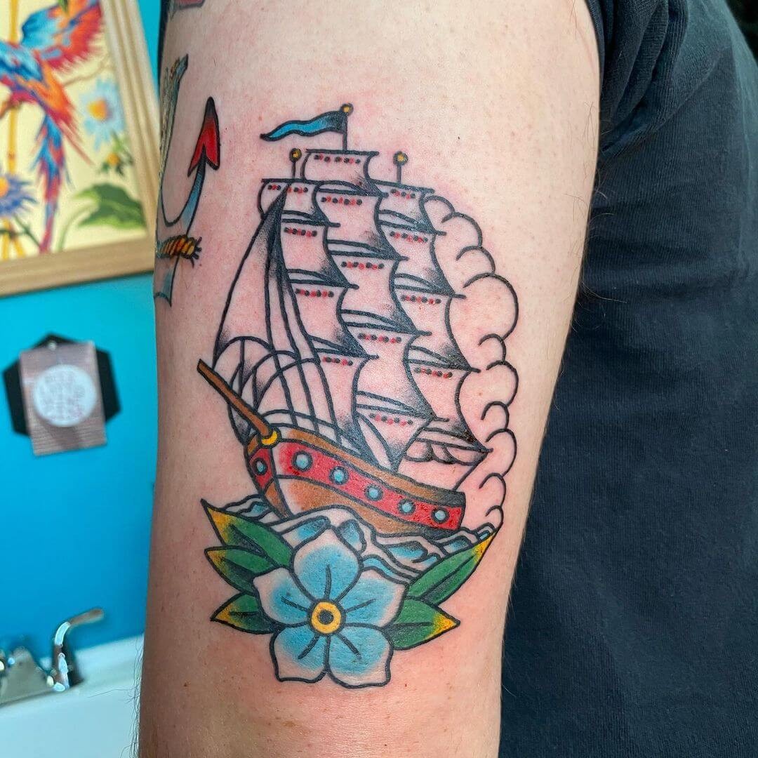 Colourful Sailboat Tattoo At The Backdrop Of A Sunset