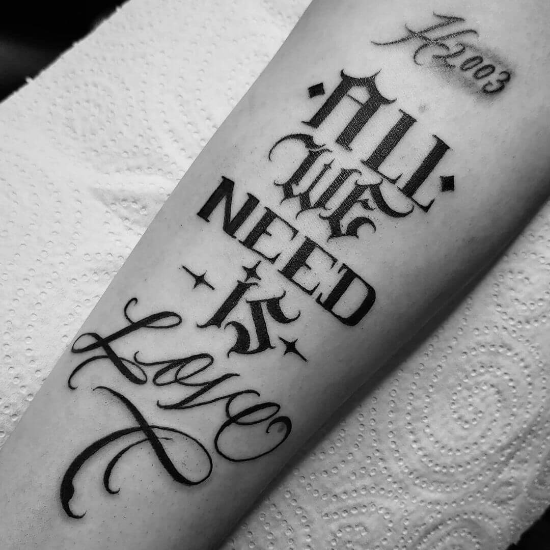 All We Need Is Love Tattoo In Mixed Fonts