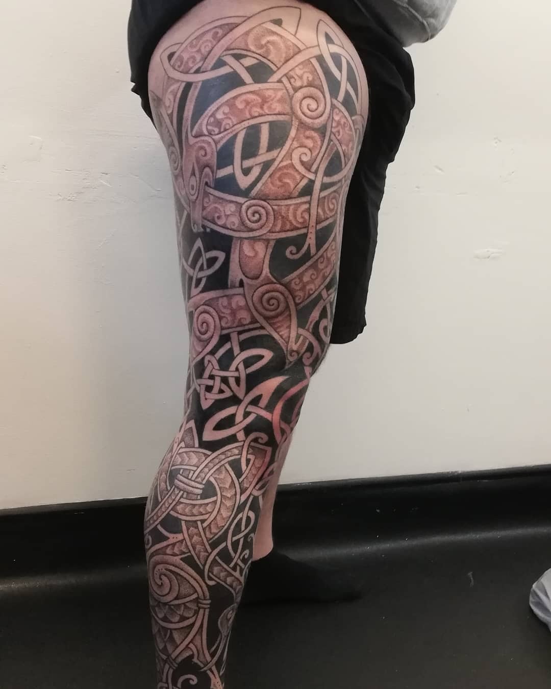 Red and black Celtic leg tattoo