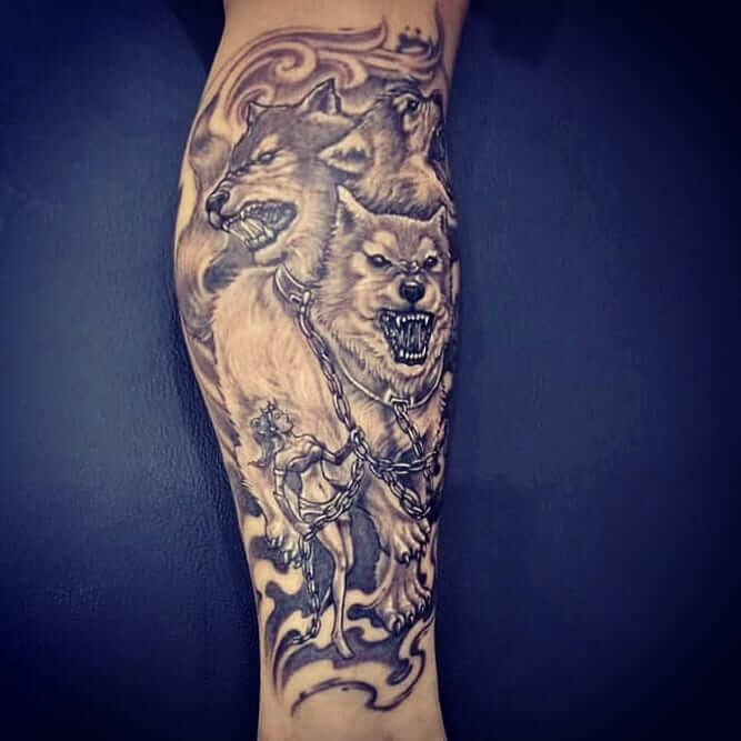 Cerberus Tattoo Sleeve Design Black And White Ink Three Head Dog In Chains On Leg