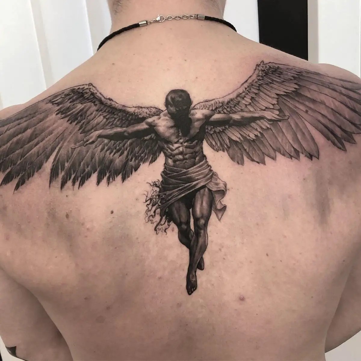 A Complex Graphic Icarus Tattoo