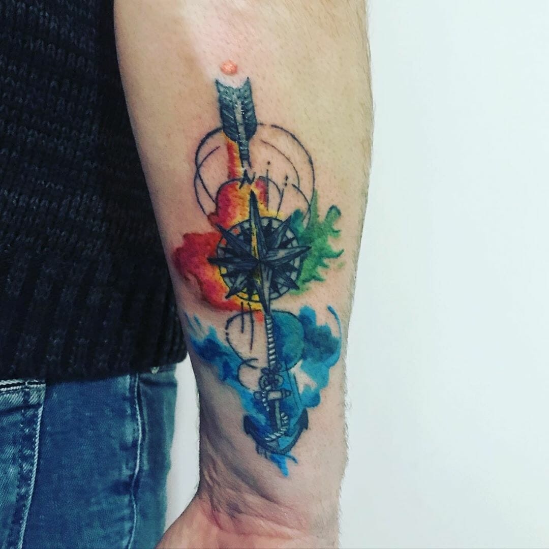 Colorful Arrow Through North Star Compass Tattoo Design Below Elbow Placement